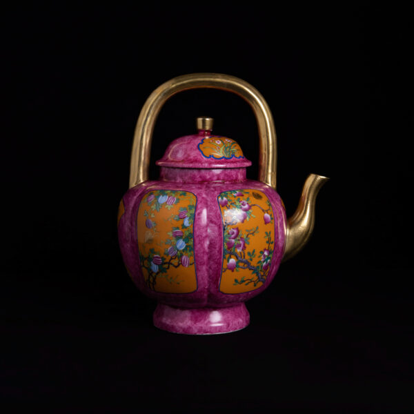 (From an Old Collection) A Rouge-Red, Yellow-Ground, Famille Rose Porcelain Teapot with Gilt Peach Design and Handle
