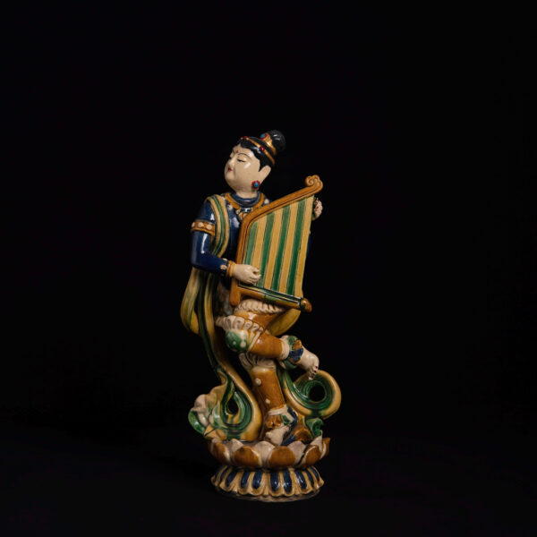 (From an Old Collection)Three-color glazed statue of a dancing celestial being holding a lute and standing upright