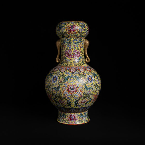 (From an Old Collection)Yellow-ground enamel-painted scroll-pattern lotus flower design gilt bottle with elephant-shaped ears and a bulbous mouthpiece