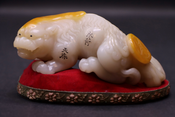Yellowtianstone carved with exquisite craftsmanship depicting ancient beasts as a piece of art.